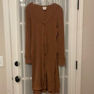 Long button up cardigan with slit sides.